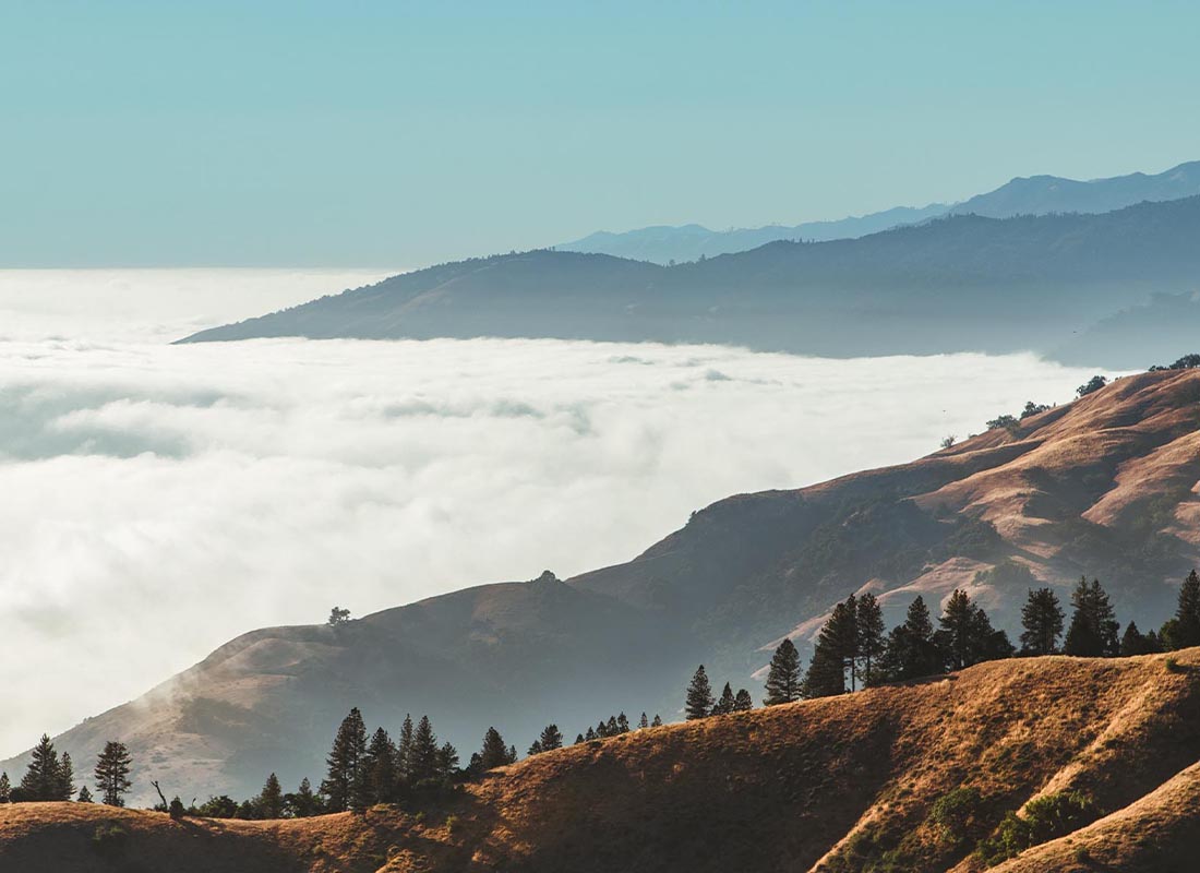 About Our Agency - Landscape View of Clouds and Mountains on a Sunny Day